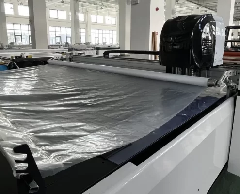 automatic fabric cutting machine plastic film covering fabric 1 495x400 - MACHINE AUTOMATIQUE DE COUPE DE TISSU