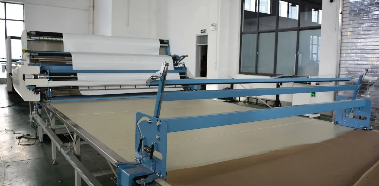 fabric spreading machine 1280x630 - Streamlining Fiberglass Fabrication: How Digital Cutting Machines are Revolutionizing Boat Building